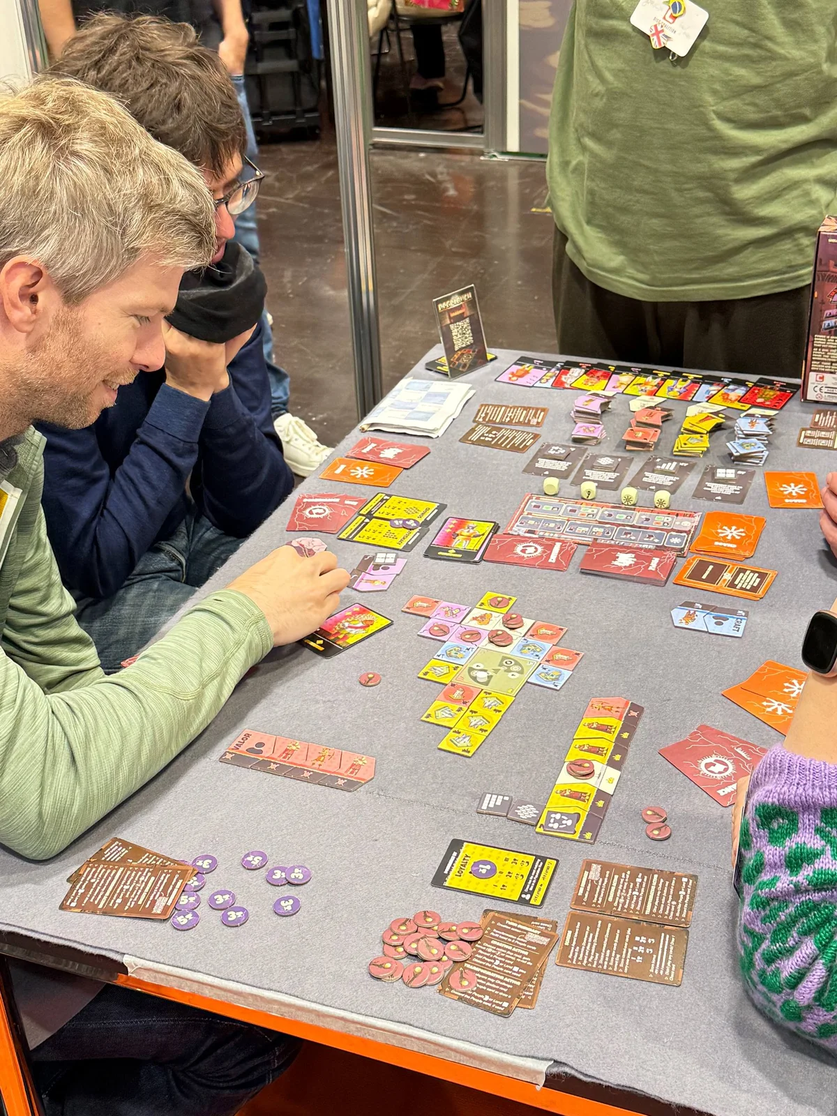 Players studying the Havocville city and faction boards
