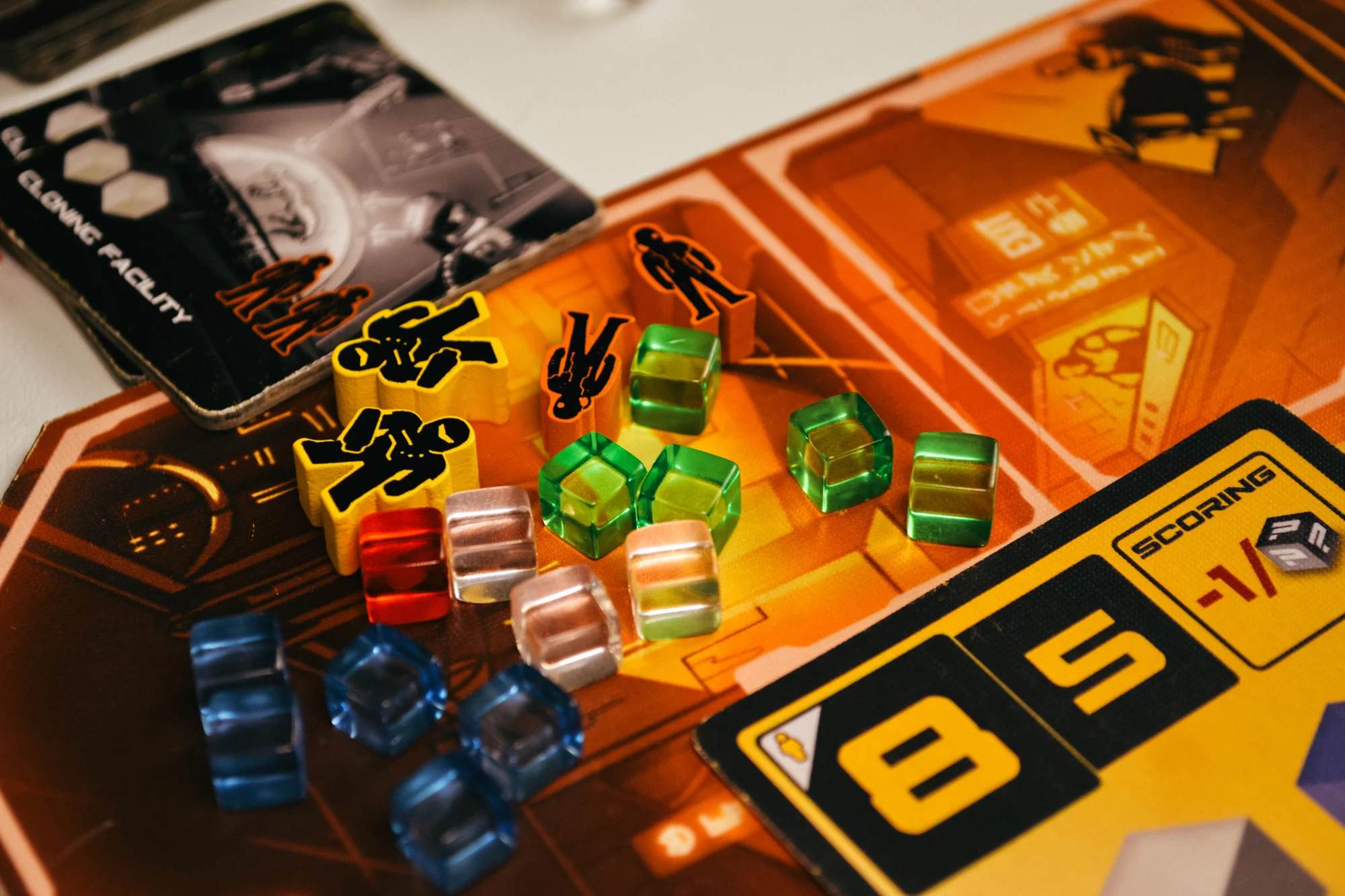 Close-up of colorful agents and translucent goods on an orange Hyperwars district board